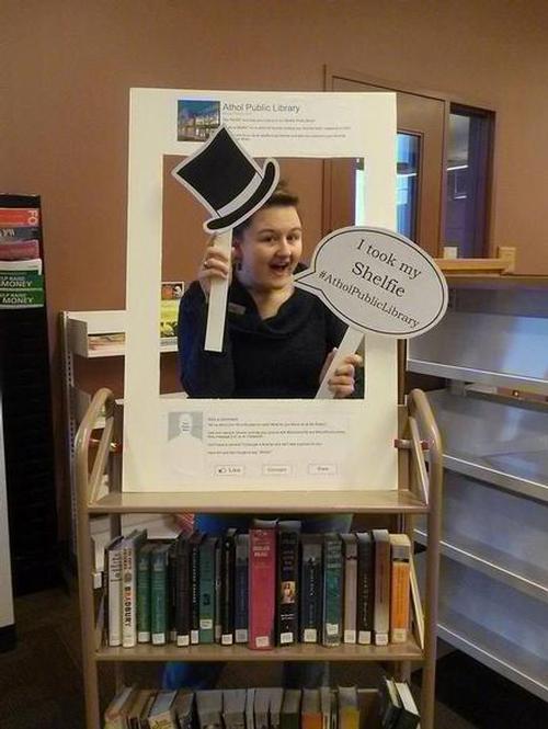 A library staff member getting into #libraryshelfie fun! Join in! #LibraryShelfie #AtholPublicLibrary.