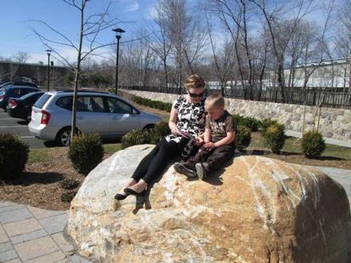 Spring has officially sprung at the Athol Public Library as Christine Moomaw reads to Parker Moomaw in the new Miller’s River Park yesterday.