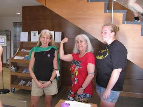 The Children’s Librarian, Library Director, & a volunteer at Super Hero Night.