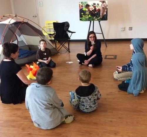 Oral Stories around the campfire in the "Book it" to the Woods program.