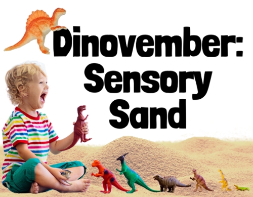 A blonde toddler with toy dinosaurs and sensory sand all around them.